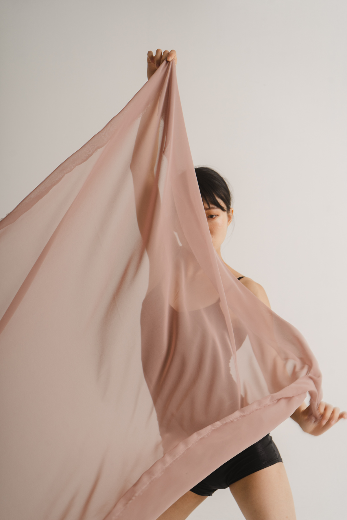 Young Woman Dancing with Beige Fabric