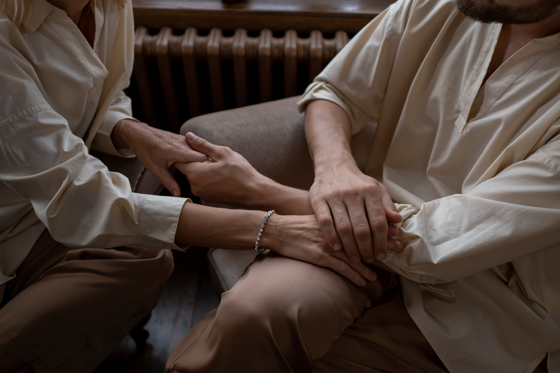 Man in Beige Dress Shirt Holding Hands of Woman in Beige Dress Shirt